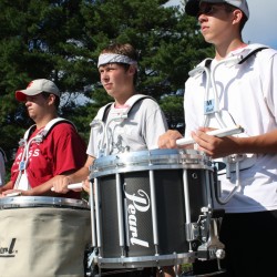A photo of 3 snare drummers.